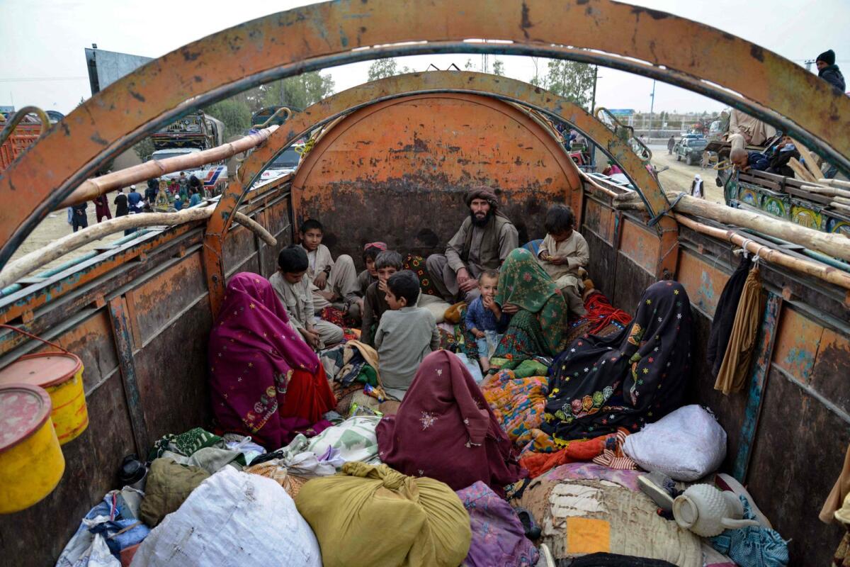 Afghan refugees with their belongings arrive on trucks from Pakistan, at a registration centre near the Afghanistan-Pakistan border in the Spin Boldak district of Kandahar province on November 6, 2023.