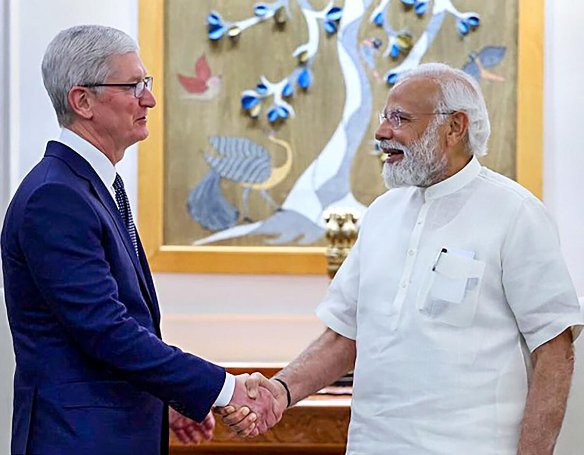 Prime Minister Narendra Modi with Apple CEO Tim Cook at a meeting in New Delhi on Wednesday.— PTI