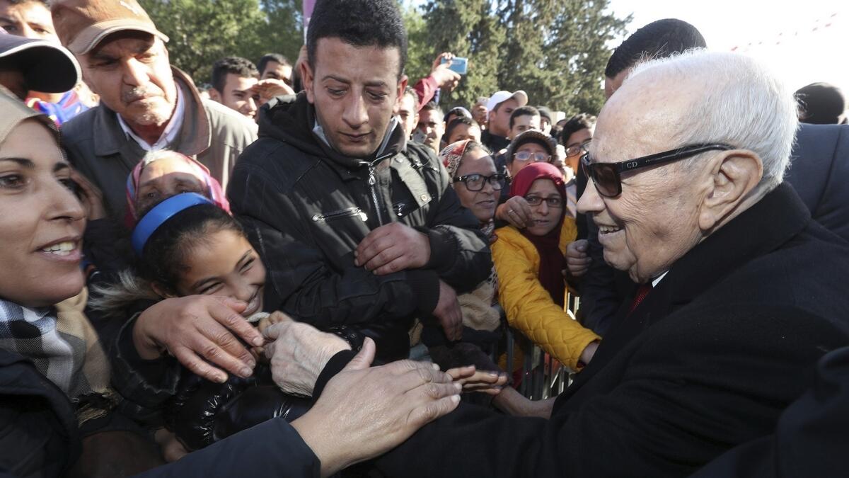 Tunisian President Beji Caid Essebsi shake hands with bystanders as he arrives for a event in Tunis, Tunisia.- AP