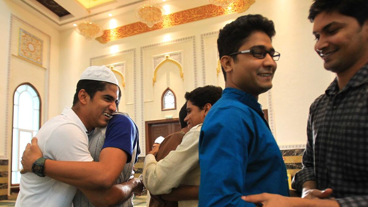 People greet each other after offering Eid prayers at Al Karama Mosque in Dubai. Photo by Neeraj Murali/Khaleej Times