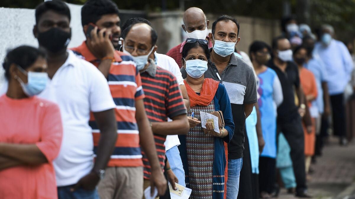 Voters, most wearing facemasks, wait in a queue to cast their ballots in the parliamentary election outside a polling station in Colombo. Sri Lankan voters cast their ballots on August 5 for a new parliament as the ruling Rajapaksa brothers seek a fresh mandate to cement their grip on power. Photo: AFP