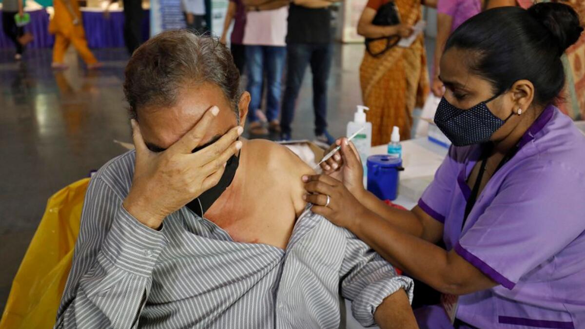 A man receives a dose of a Covid-19 vaccine at a temporary vaccination centre in Ahmedabad, India.