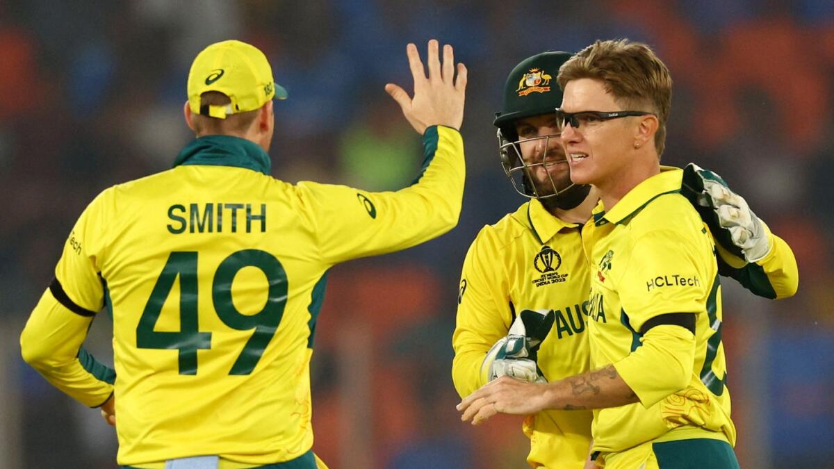 Australia's Adam Zampa celebrates with Josh Inglis and Steve Smith after taking a wicket. - AFP