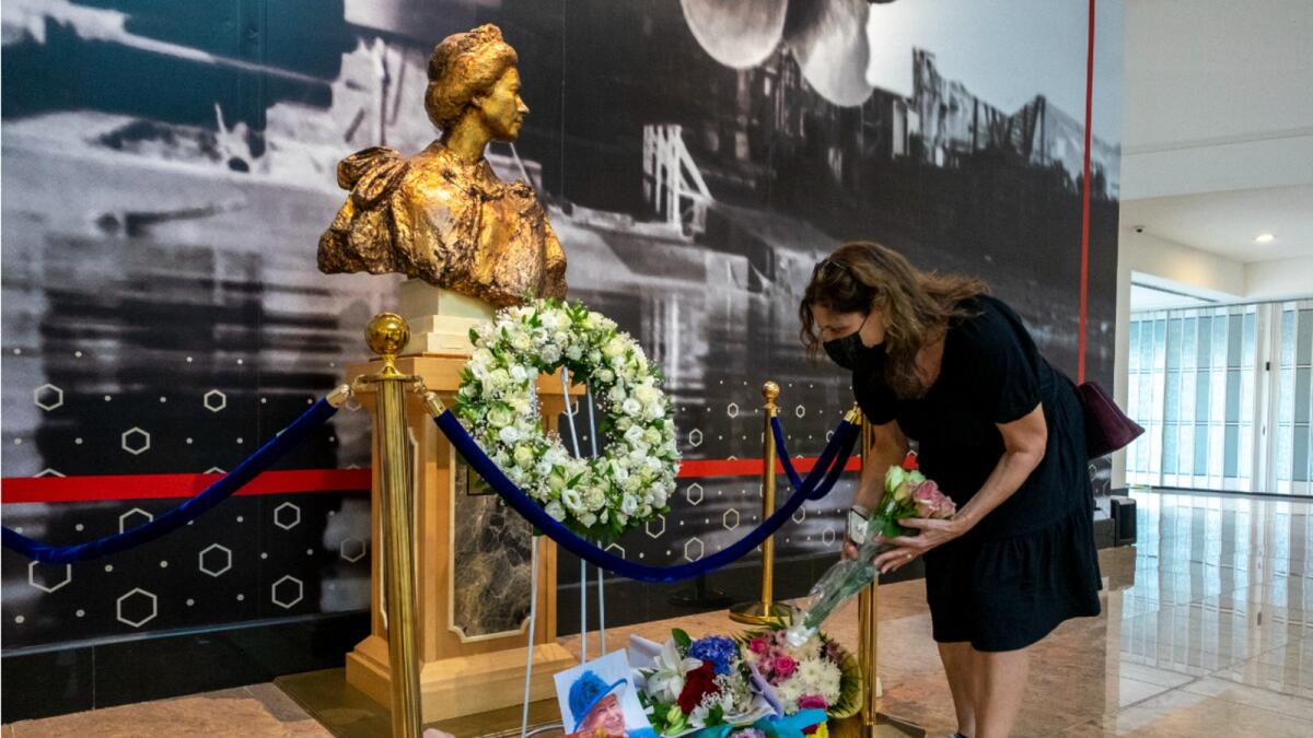 A visitor pays respect to Queen Elizabeth II at floating luxury hotel QE2 in Dubai. — Photos by Shihab