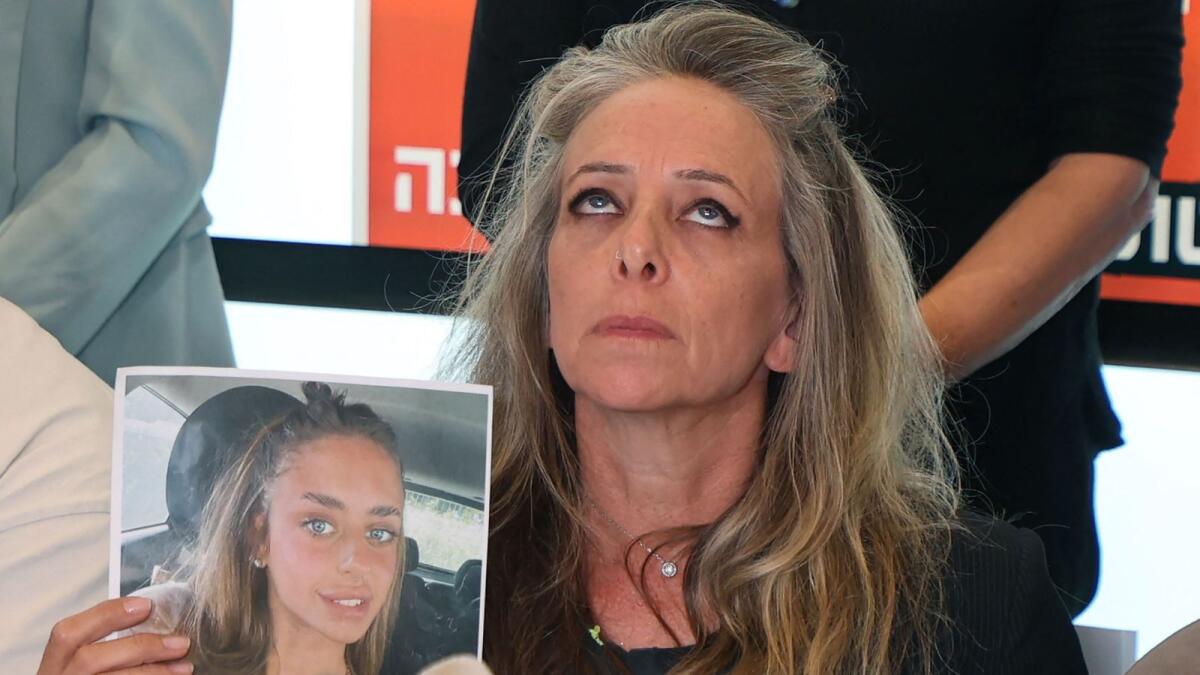 Keren Shem, the mother of French-Israeli woman Mia Shem, holds a photograph of her daughter. — AFP file