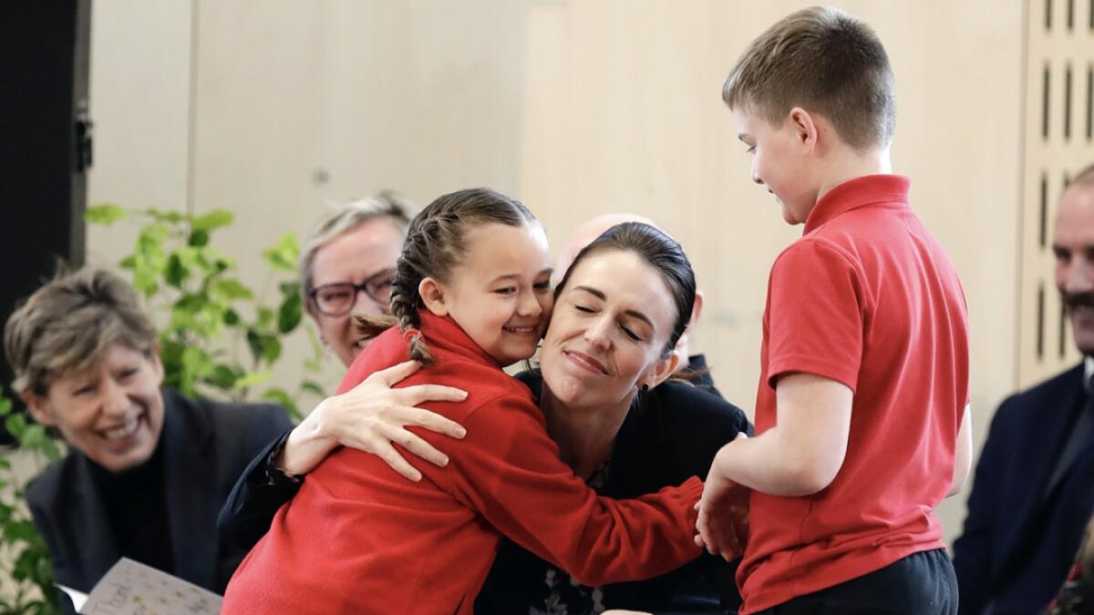 New Zealand Prime Minister Jacinda Ardern embraces a pupil during the opening ceremony for Redcliffs School in Christchurch, New Zealand. The school was rebuilt following earthquakes almost nine years to the day forced pupils and staff from the site. Photo: AP