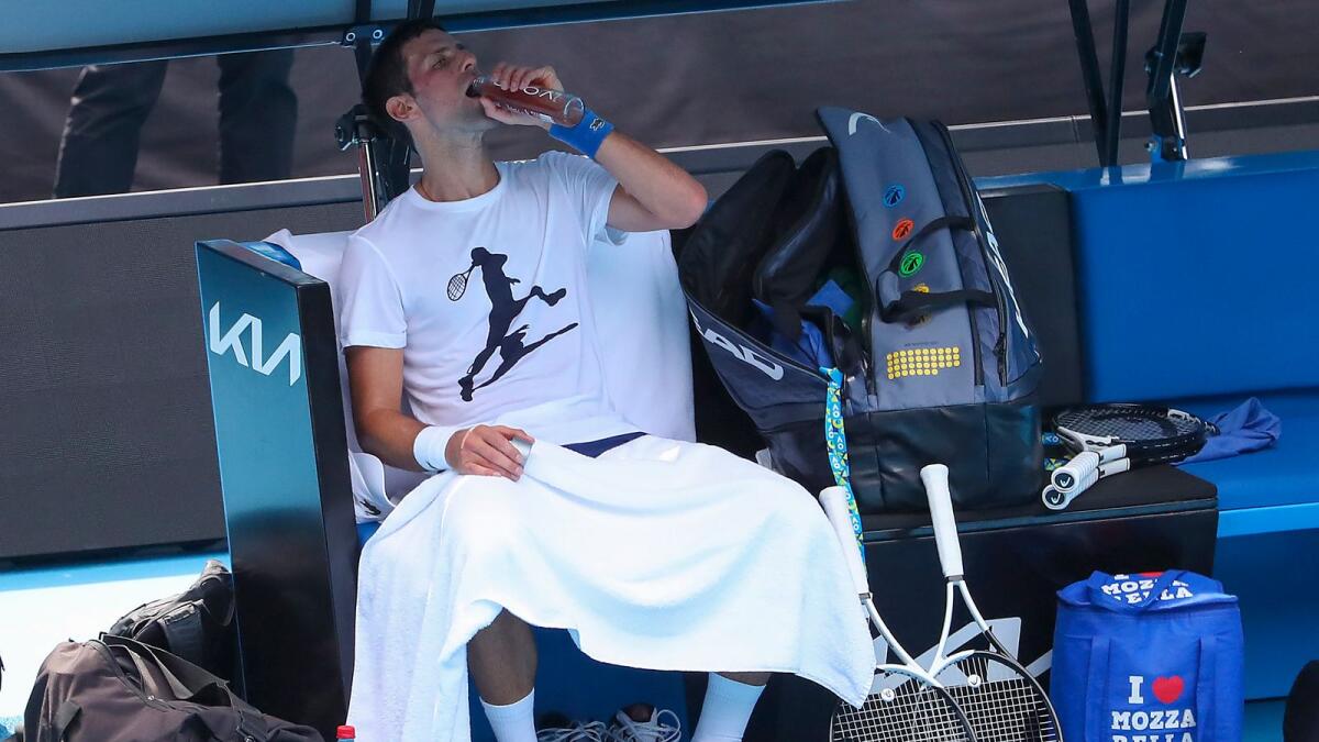Djokovic takes a drinks break during the practice session on Tuesday. (AP)