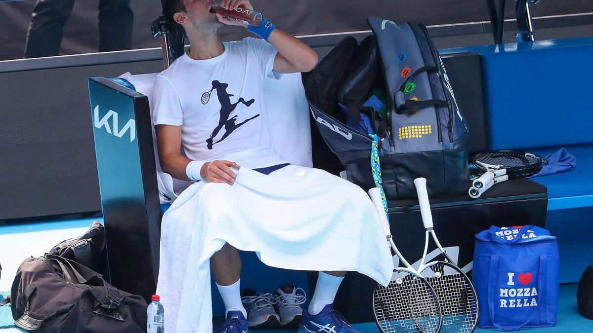Djokovic takes a drinks break during the practice session on Tuesday. (AP)