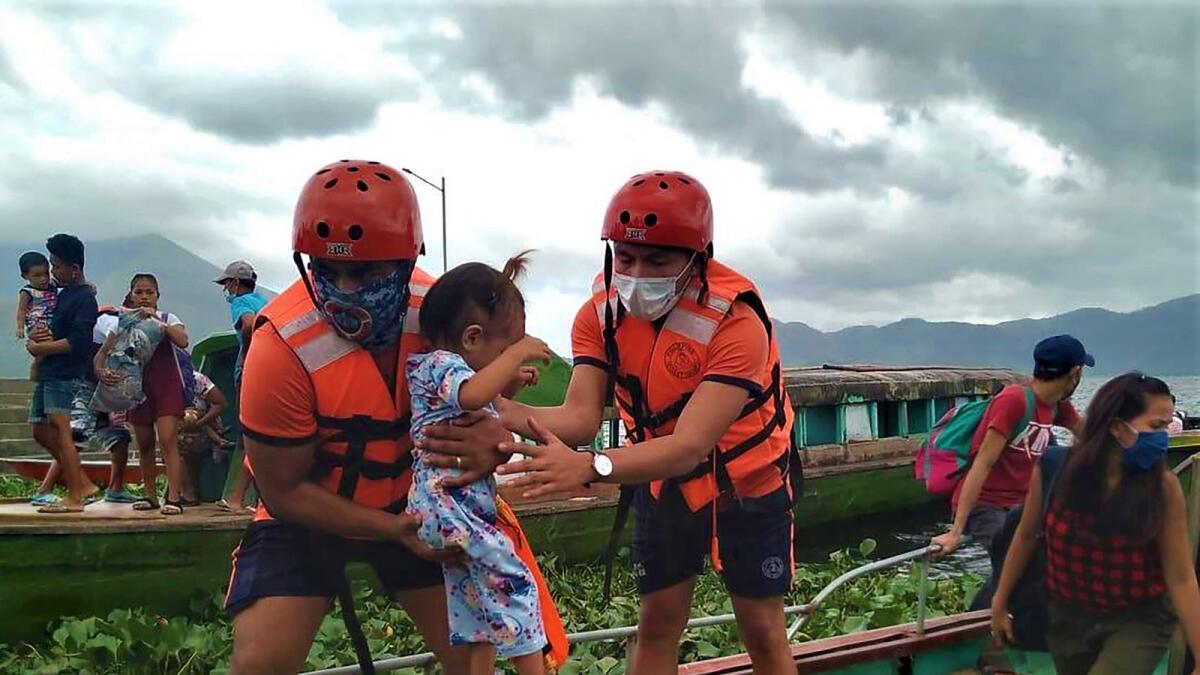 A handout photo shows personnels from the coast guard evacuating residents from the coastal villages of Buhi town, Camarines Sur province, south of Manila, to a safer place, ahead of Typhoon Goni's landfall. AFP