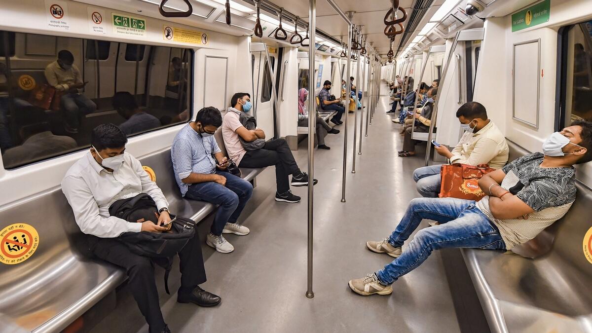 Commuters travel in metro train as Delhi Metro resumes operations in a graded manner, in New Delhi. The Delhi Metro resumed services with curtailed operation of the Yellow Line on Monday after being closed for over five months due to the novel coronavirus pandemic. Photo: PTI