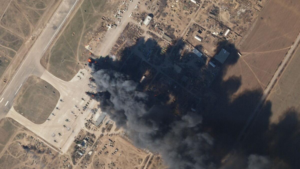 This Planet Labs satellite image taken on March 15, 2022 and released on March 16, 2022 shows Kherson airbase on fire after an alleged airstrike against Russian forces occupying the base. Photo: AFP