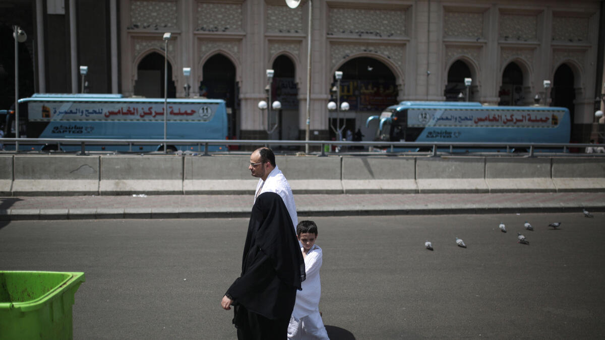 A Muslim pilgrim family walks outside the Grand Mosque(AP Photo)