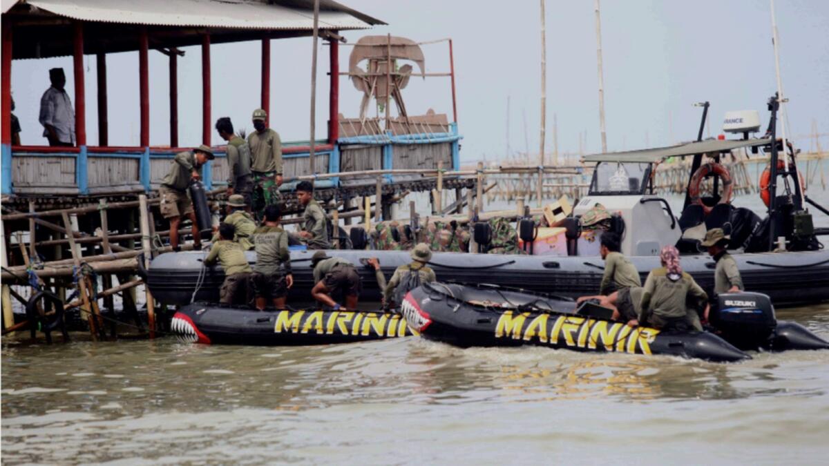 Divers head out to look for the black boxes of Sriwijaya flight SJY182 from Tanjung Kait in Tangerang, on the outskirts of Jakarta. — AFP