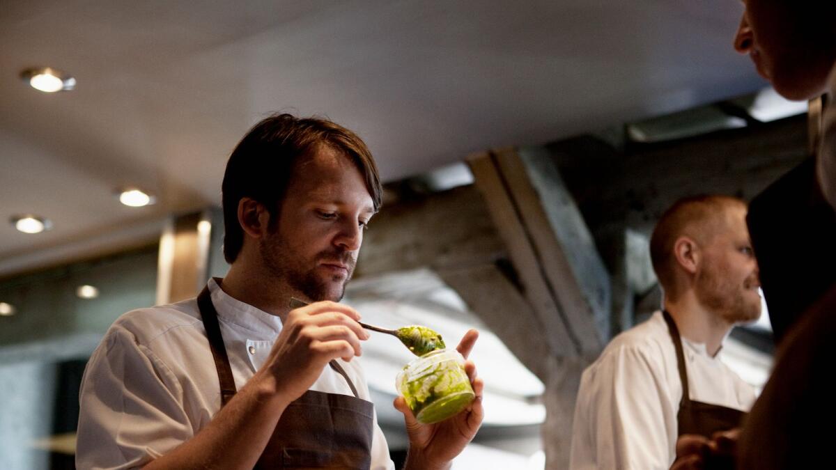 Rene Redzepi, center, chef of Noma who practices a earthly style of cooking known as 'new Nordic,' works in the kitchen at the restaurant, in Copenhagen, June 21, 2010.