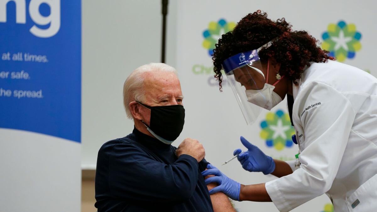 US President-elect Joe Biden receives a Covid-19 vaccination from Tabe Masa, Nurse Practitioner and Head of Employee Health Services, at the Christiana Care campus in Newark, Delaware on December 21, 2020.