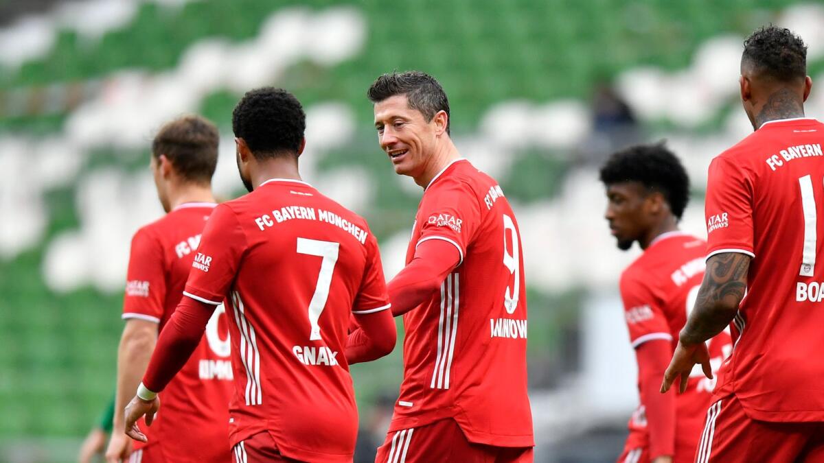Bayern's Robert Lewandowski (centre) celebrates with Serge Gnabry after scoring his side's third goal during the German Bundesliga match against Werder Bremen. — AP