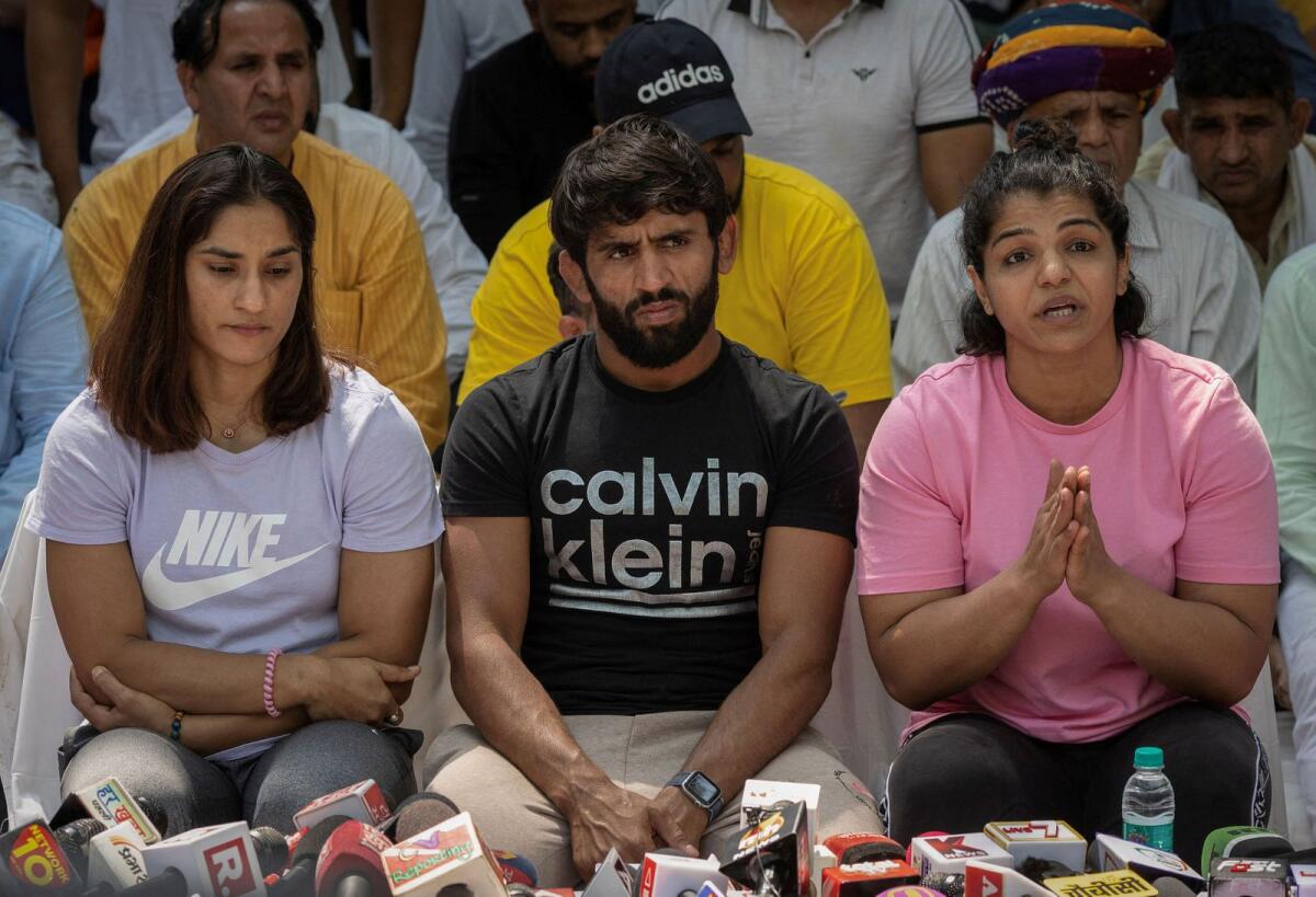 Indian wrestlers Vinesh Phogat, Bajrang Punia, and Sakshi Malik address a news conference as they take part in a sit-in protest demanding arrest of Wrestling Federation of India chief, who they accuse of sexually harassing female players, in New Delhi, India, on April 24, 2023. Photo: Reuters