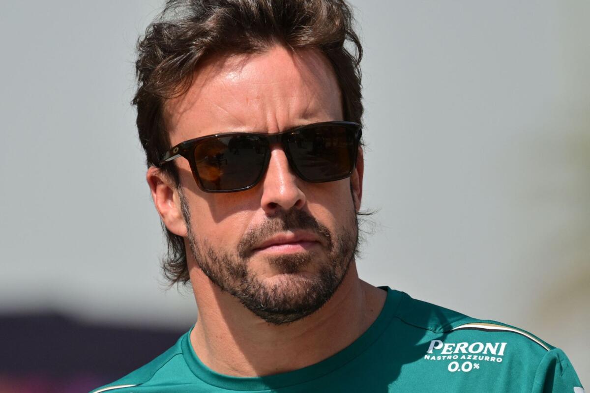 Aston Martin's Spanish driver Fernando Alonso arrives at the paddock before the third practice session of the Formula One Bahrain Grand Prix at the Bahrain International Circuit in Sakhir on Saturday. — AFP