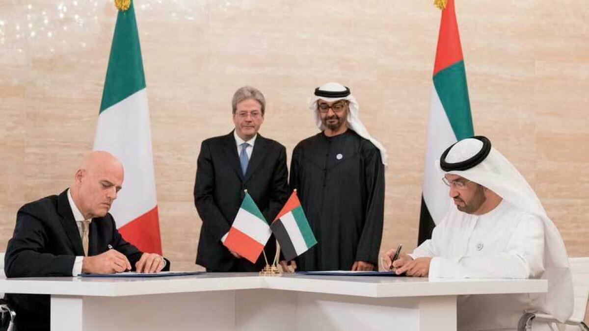 Sheikh Mohamed and Paolo Gentiloni look on as Dr Sultan Ahmed Al Jaber and Claudio Descalzi sign deals that awarded the Italian firm two concessions in Abu Dhabi oil and gas sector.—Twitter image