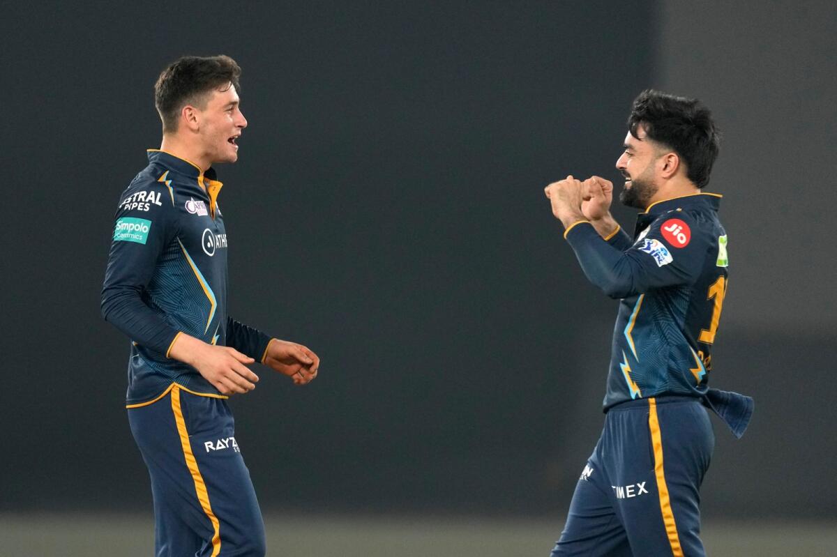Gujarat Titans' Noor Ahmad (left) celebrates with teammate Rashid Khan. — AP