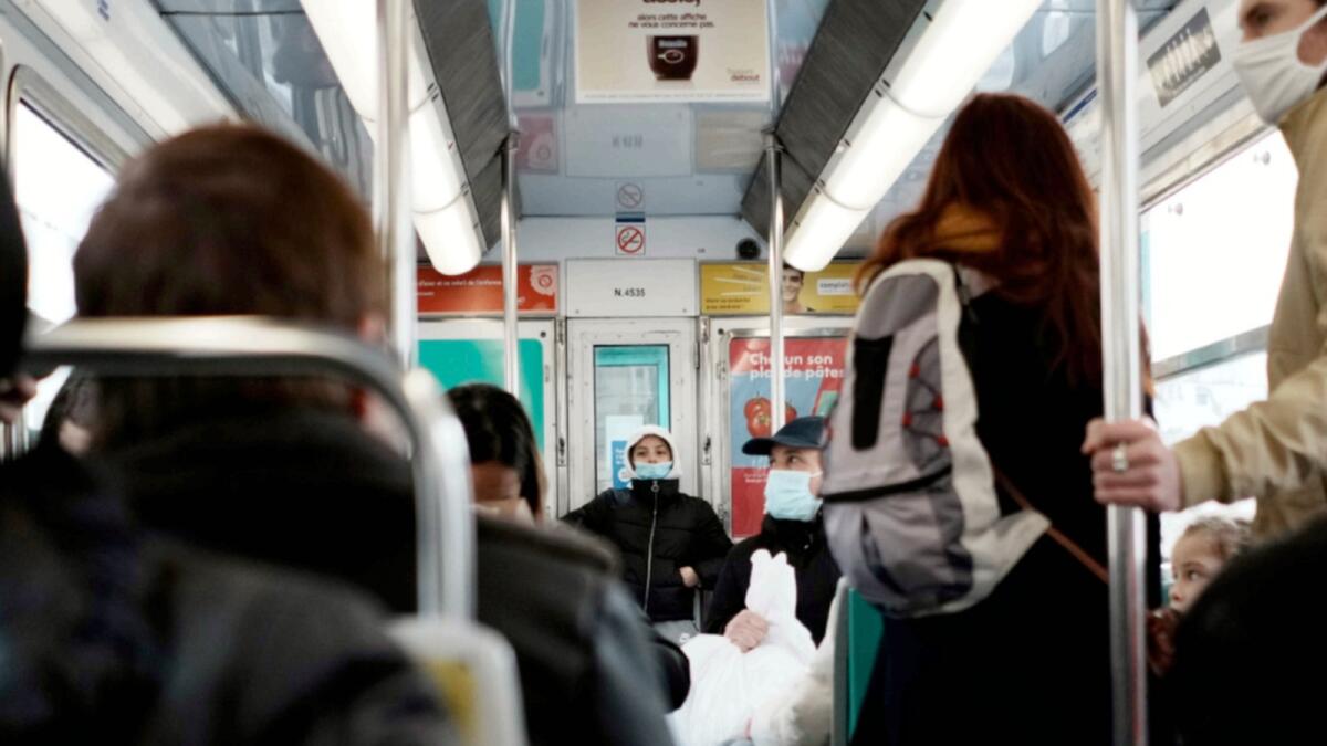Commuters wears face mask to protect against Covid-19 in a metro, in Paris. — AP