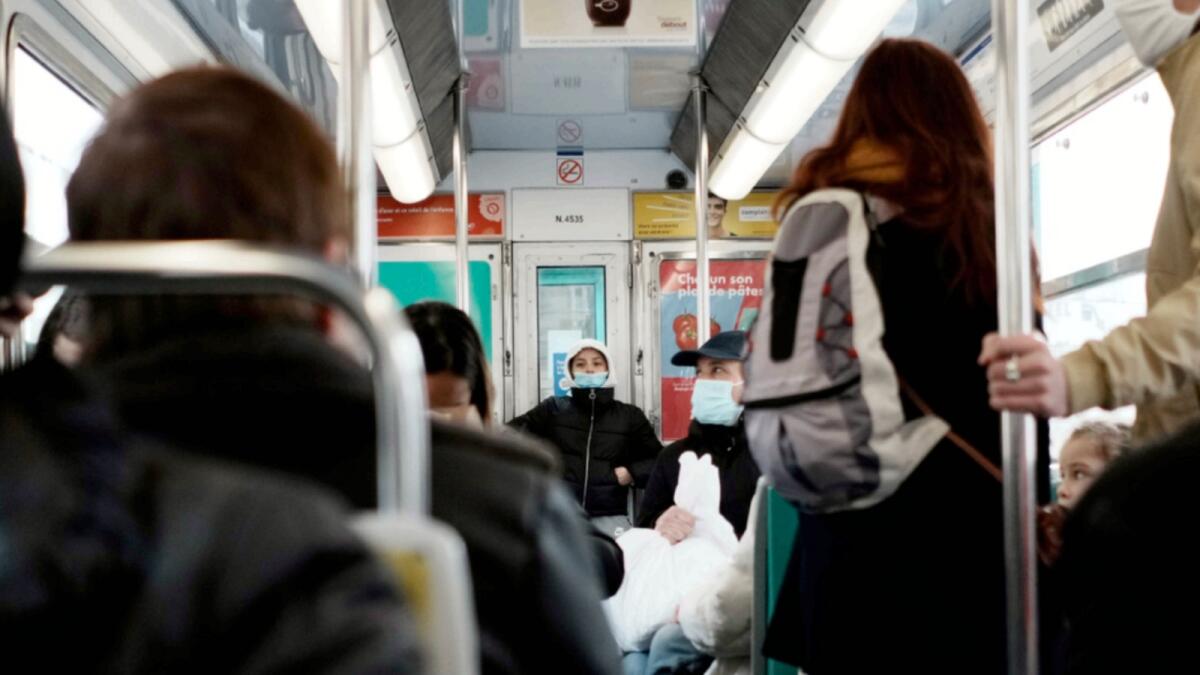 Commuters wears face mask to protect against Covid-19 in a metro, in Paris. — AP