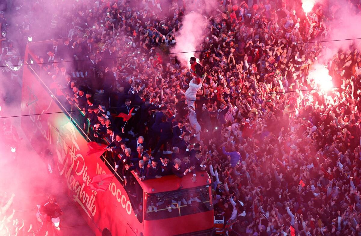 Morocco players are pictured on the bus as Morocco fans celebrate with flares during the bus parade. Photo: Reuters