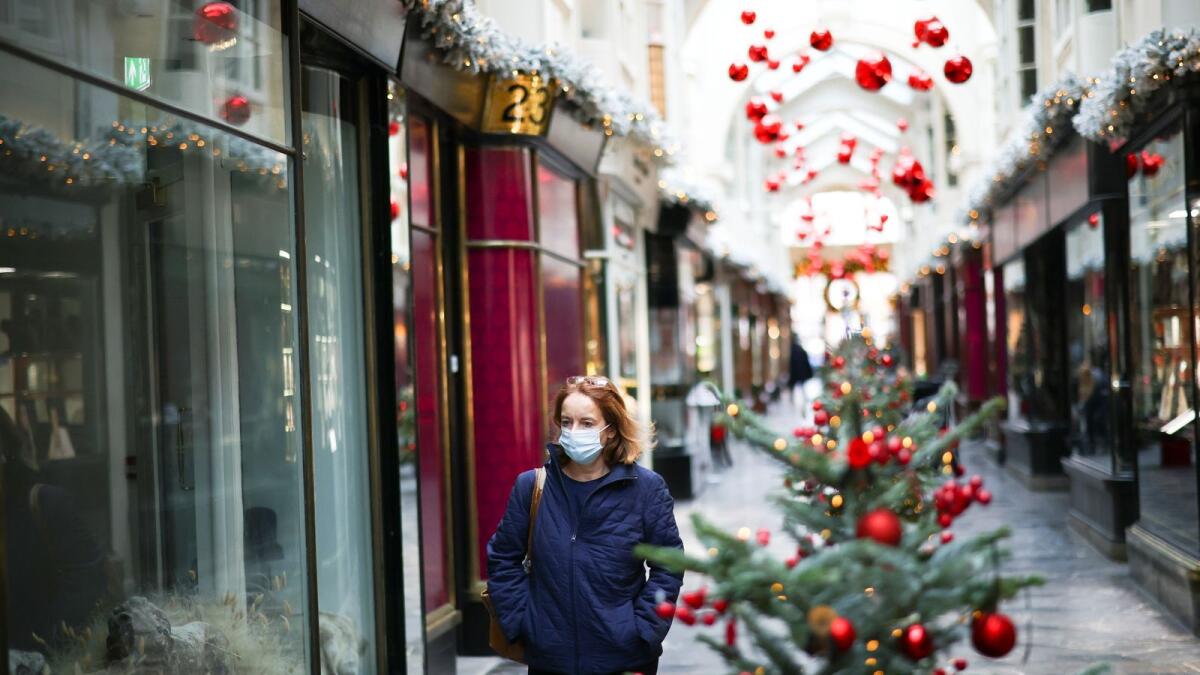 A woman walks through the Burlington Arcade adorned with Christmas decorations, in London, Britain, November 23, 2020.