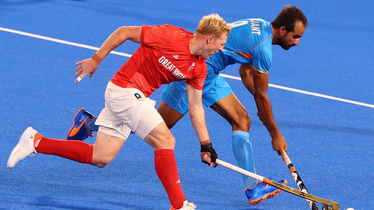 Rupert Shipperley of Britain in action against Gurjant Singh of India.— Reuters