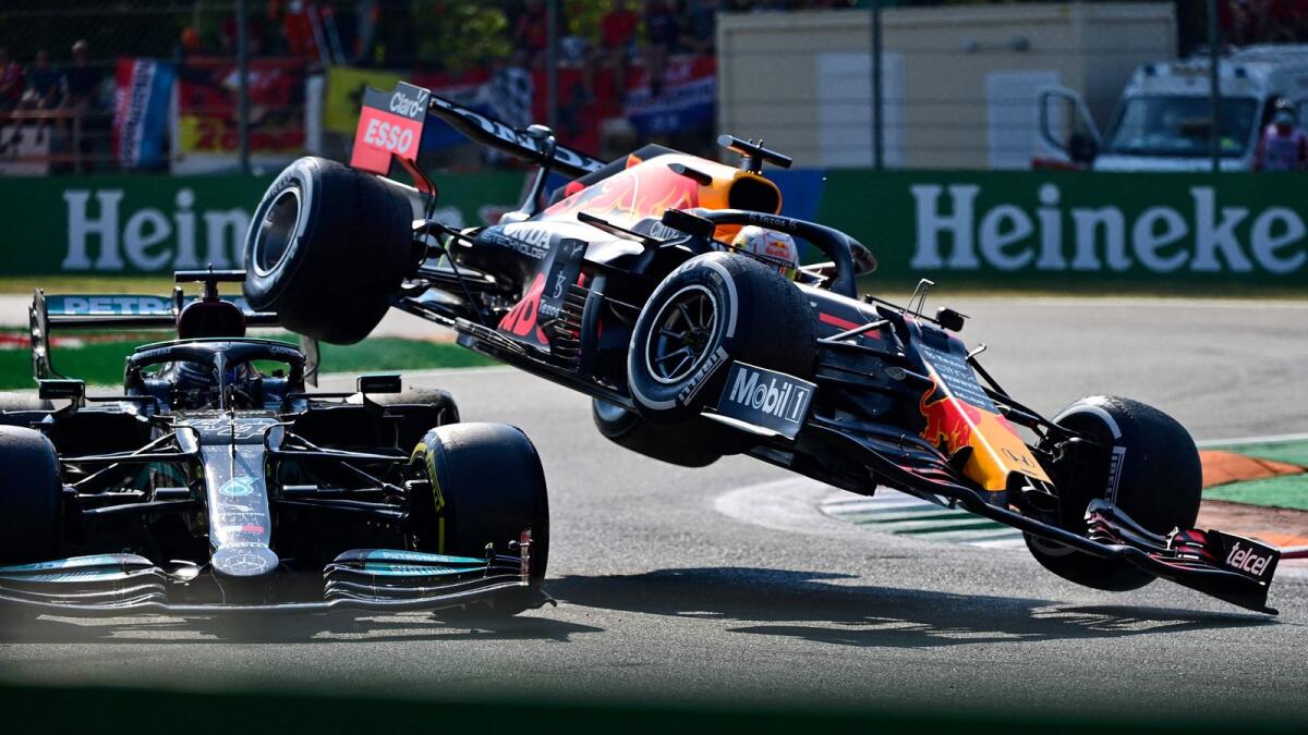 Mercedes' British driver Lewis Hamilton (left) and Red Bull's Dutch driver Max Verstappen collide during the Italian Formula One Grand Prix. — AFP