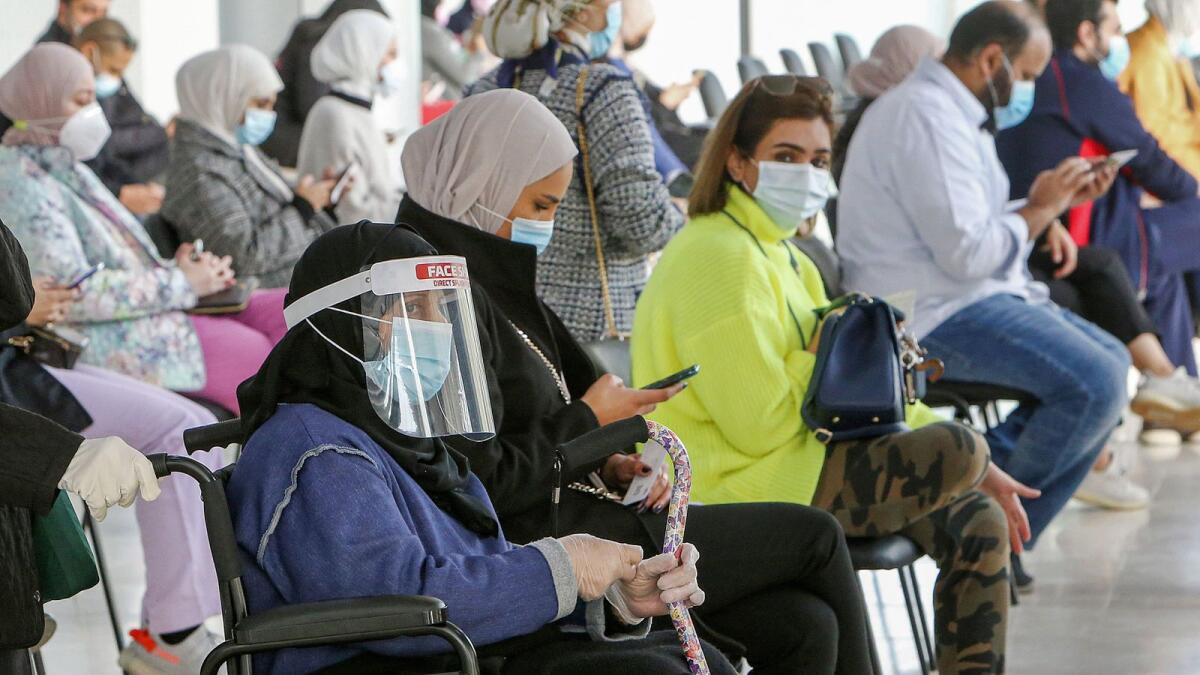 People wait for their turn to be vaccinated for Covid-19 in the Mishref suburb south of Kuwait City. — AFP file