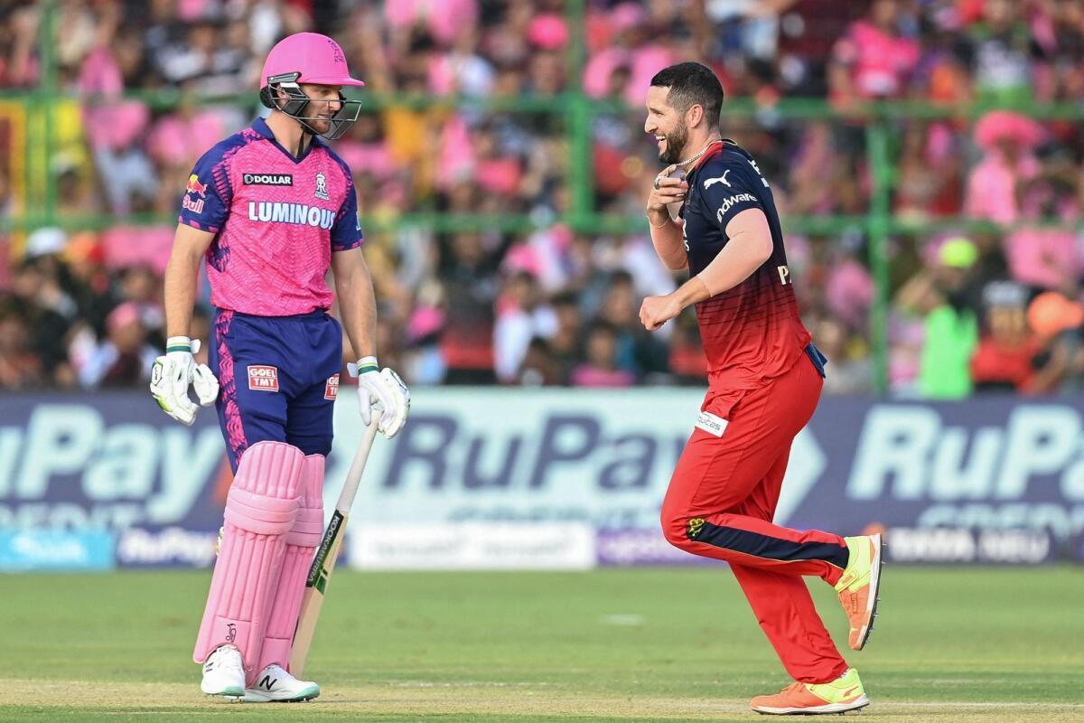Royal Challengers Bangalore's Wayne Parnell (right) celebrates after taking the wicket of Rajasthan Royals' Jos Buttler. — AFP