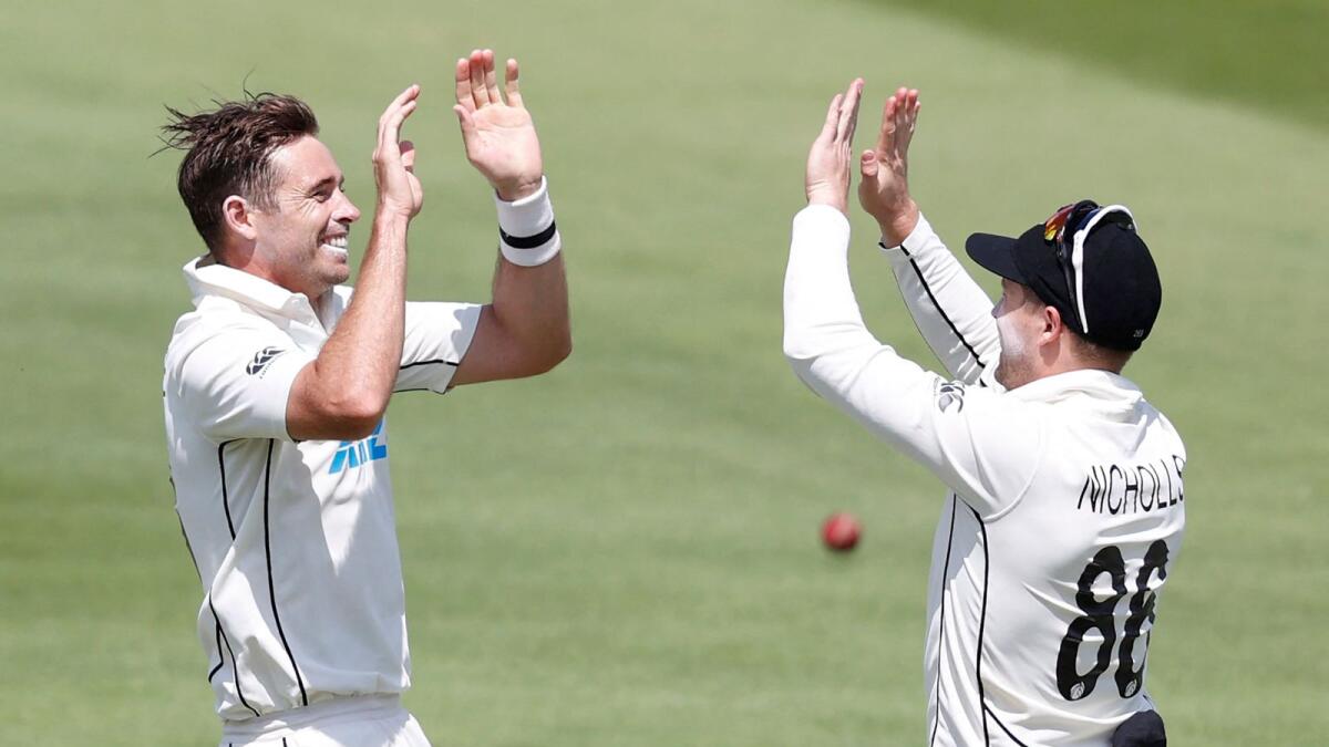 New Zealand's Tim Southee (left) celebrates with New Zealand's Henry Nicholls after taking the wicket of England's James Bracey. — AFP