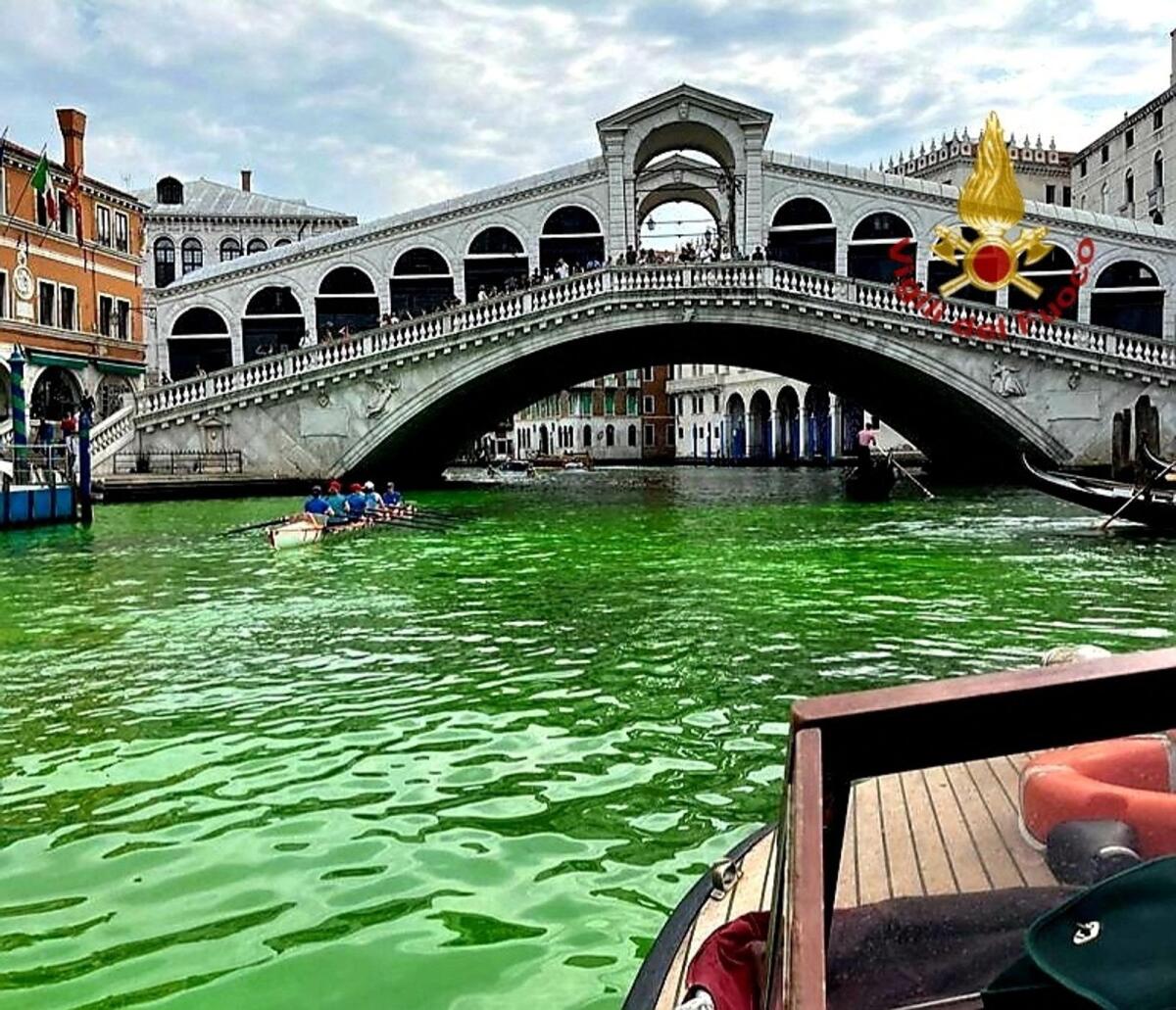 Venice's waters turn green due to an unknown substance near the Rialto Bridge, in Venice, Italy, on Sunday. — Reuters