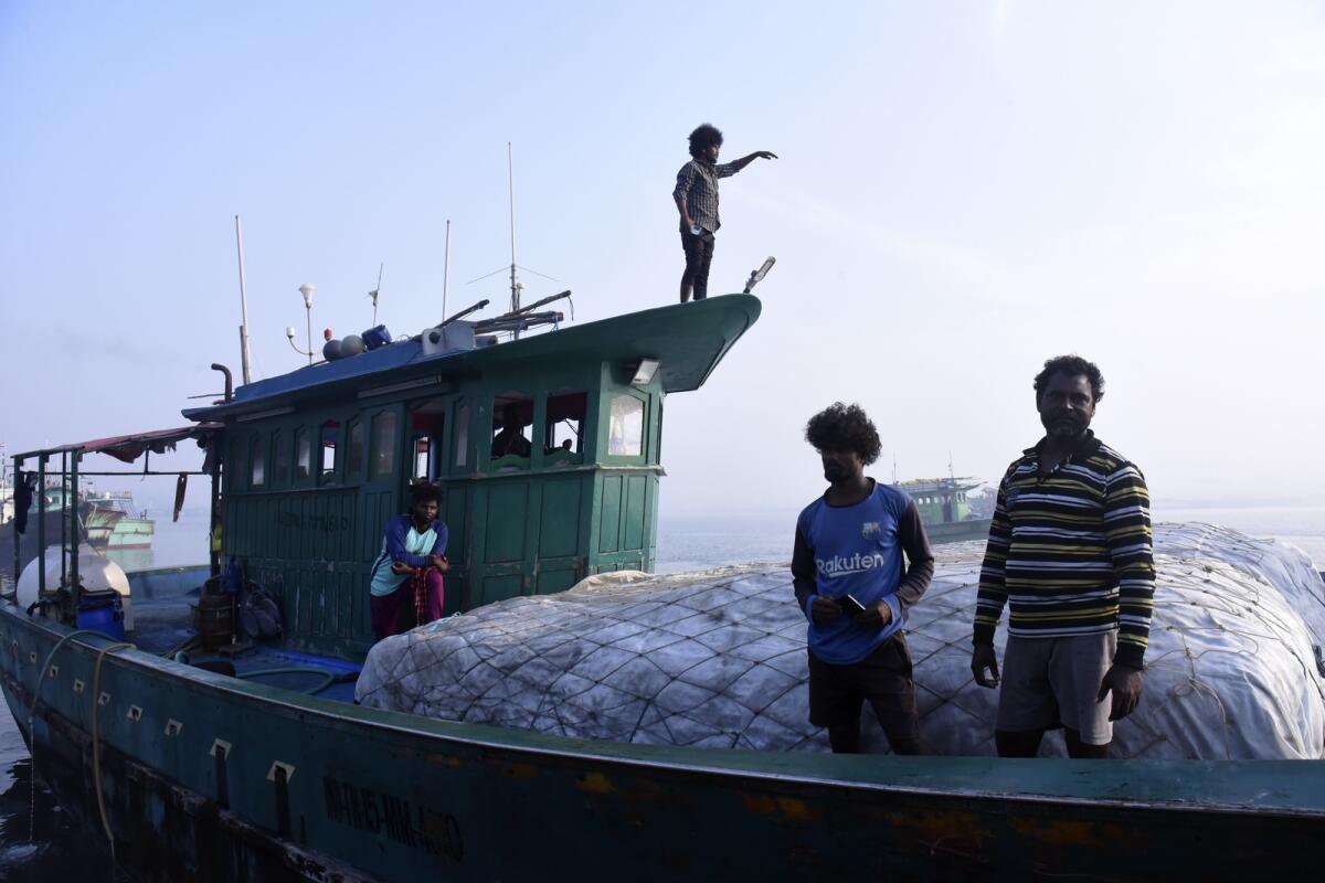Fisherman work on a boat on March 3, 2023, in Kochi, Kerala state, India. — AP