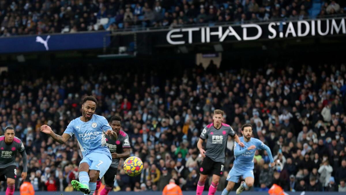 Manchester City's Raheem Sterling scores his side’s fourth goal from the penalty spot during the Premier League match against Leicester City. (AP)