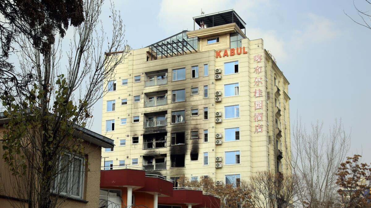 A hotel building sits charred after an attack in Kabul, Afghanistan, on Tuesday. — AP