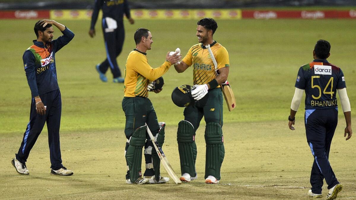 South Africa's Quinton de Kock (second left) celebrates with teammate Reeza Hendricks after South Africa won by 10 wickets during the third and final Twenty20 match against Sri Lanka. — AFP