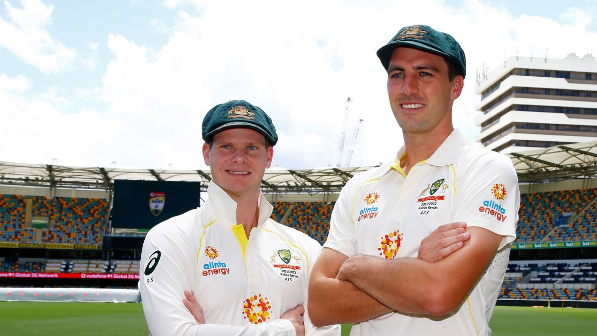 Steve Smith (left) and the Australian captain Pat Cummins pose for a photo at the Gabba ahead of the first Ashes Test in Brisbane. (AP)