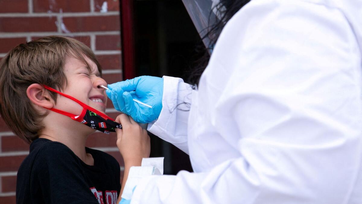 A 7-year-old boy is tested for Covid-19 at Seneca High School a day before returning to school in Louisville, Kentucky. — Reuters