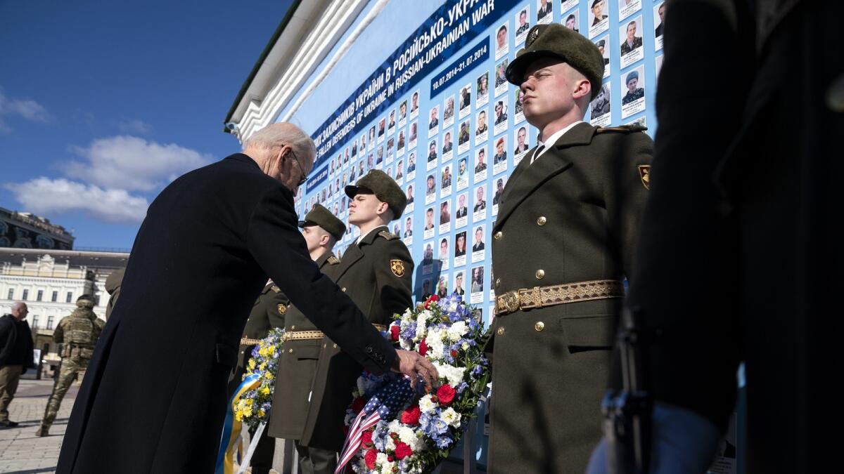 Joe Biden participates in a wreath laying ceremony at the memorial wall outside of St. Michael's Golden-Domed Cathedral in Kyiv. — AP