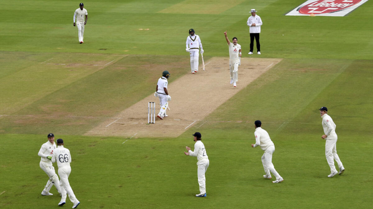 England's James Anderson (top second right) celebrates the dismissal of Pakistan's Asad Shafiq during the third day of the third cricket Test match in Southampton on Sunday. - AP