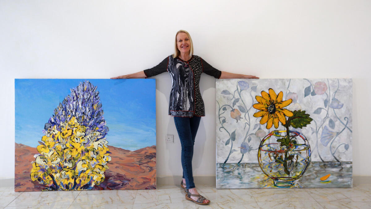 Sue Averell with her paintings.— Photo by Nezar Balout