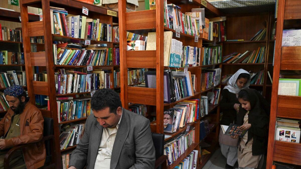 People read books inside the Darra Adam Khel Library in Darra Adamkhel town. — AFP