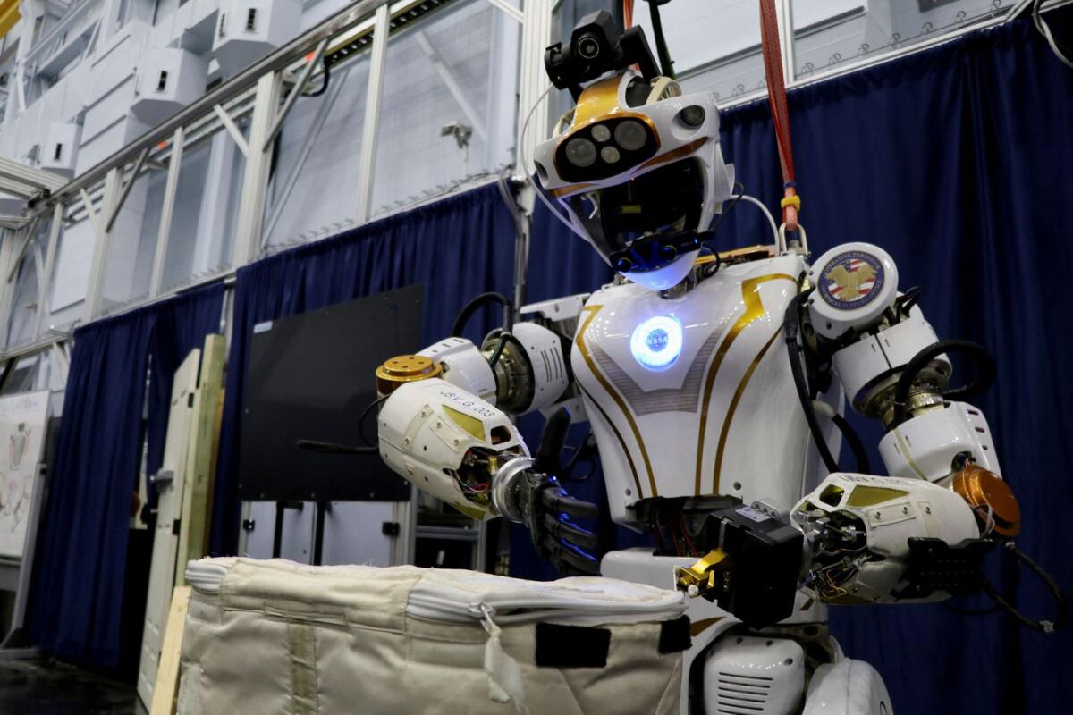 Nasa's humanoid robot Valkyrie opens a bag at the Johnson Space Center in Houston, Texas. — Reuters