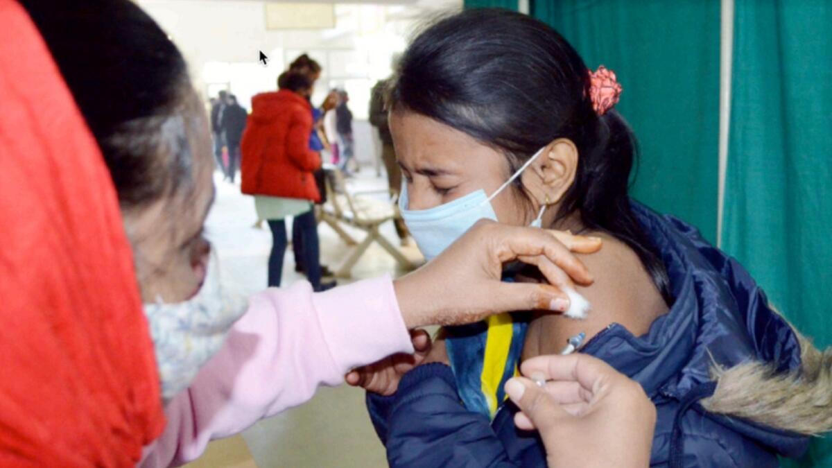 A health worker administers a dose of Covid-19 vaccine to a beneficiary at a vaccination centre in India. — ANI