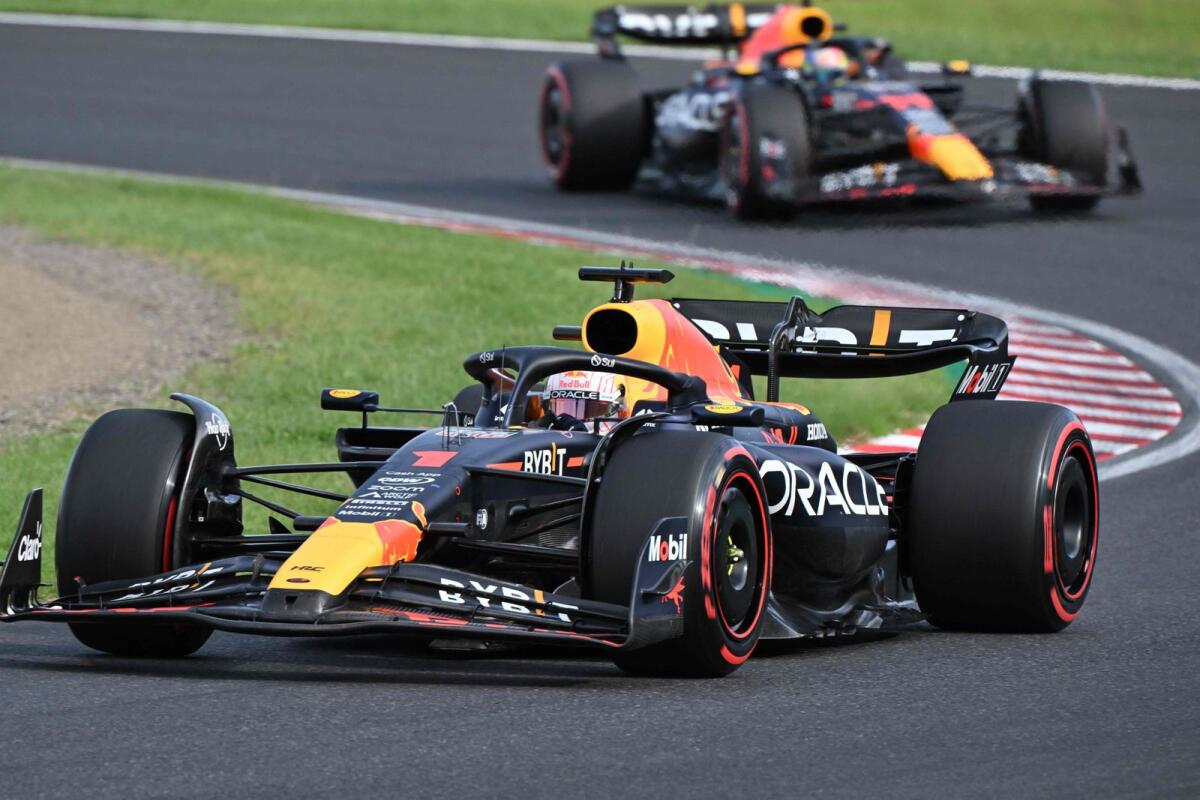 Red Bull Racing's Dutch driver Max Verstappen leads ahead of Red Bull Racing's Mexican driver Sergio Perez. - AFP