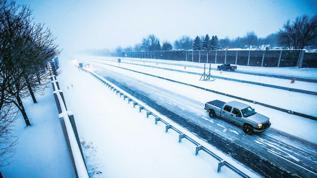 Vehicles travel along 441 during a snowstorm in Appleton, Wisconsin. Authorities in Illinois, Michigan and Wisconsin put emergency measures in place to handle the frigid weather.— AP