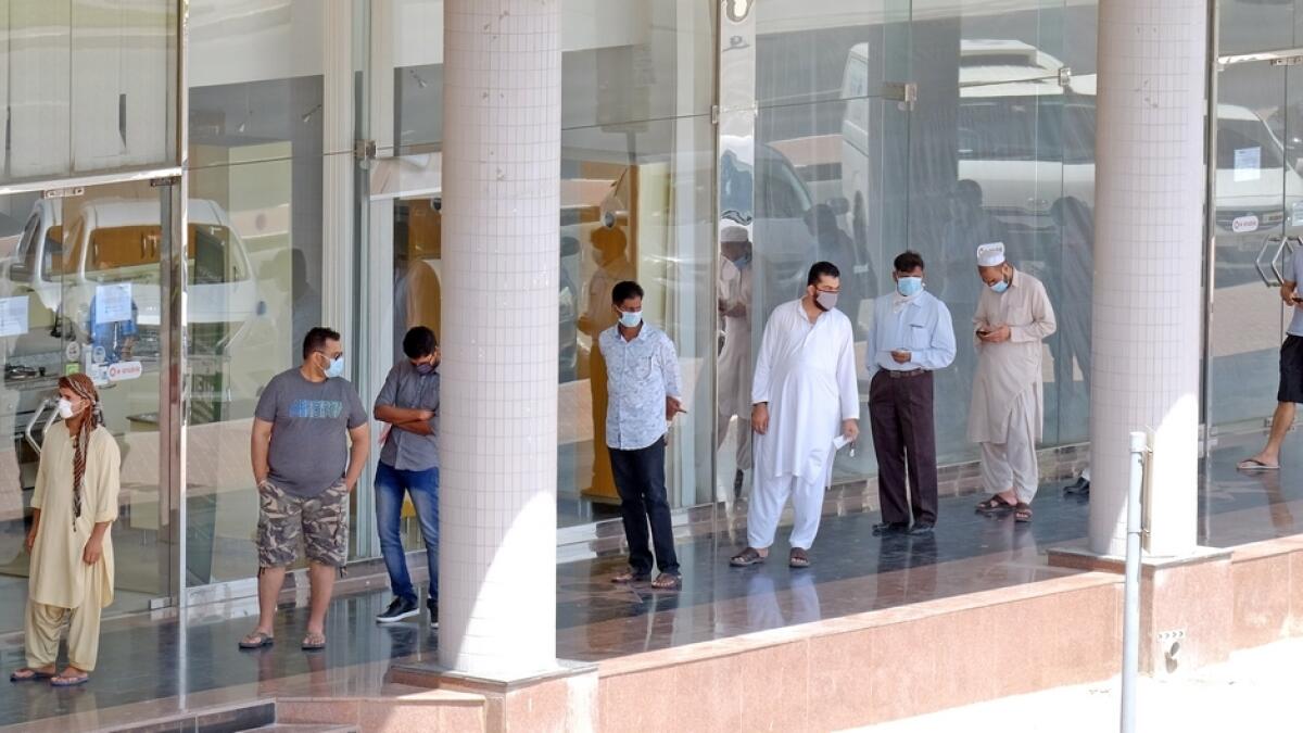 Residents wait in queue at an ATM in Dubai.