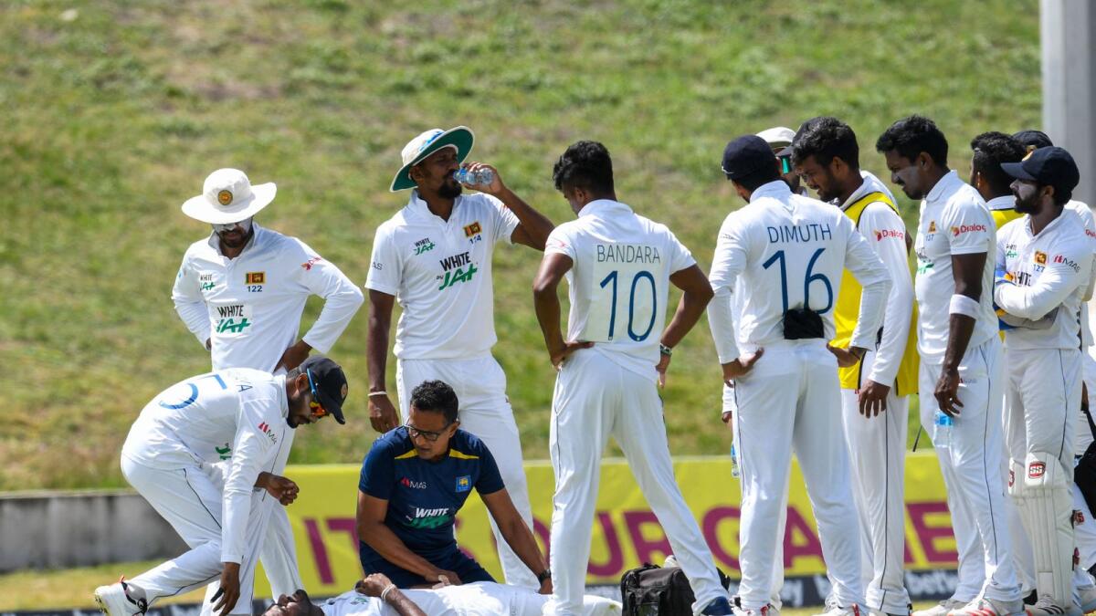 Lasith Embuldeniya of Sri Lanka is helped during day 4 of the 2nd Test between West Indies and Sri Lanka at Vivian Richards Cricket Stadium in North Sound, Antigua and Barbuda,. — AFP